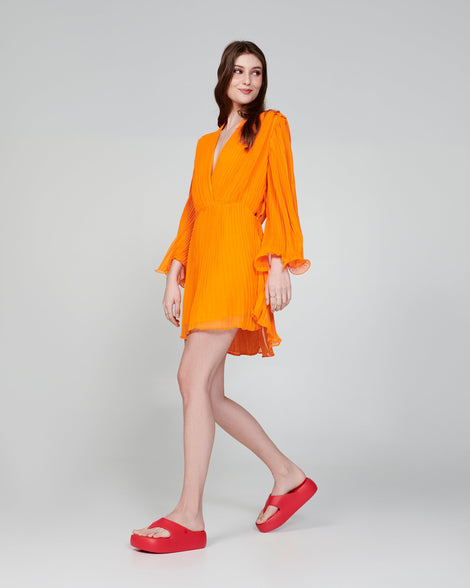 Model in an orange dress wearing a pair of beige Free Platform Thongs