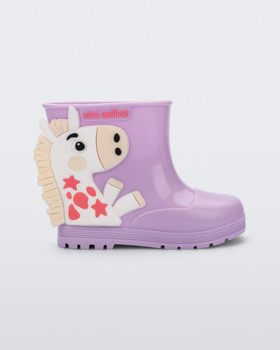 Side view of a lilac Welly Wonderland baby boot with white pony on side