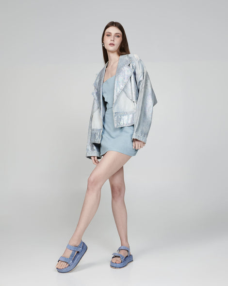 Model in a blue outfit wearing a pair of blue jean Flowing Denim platforms