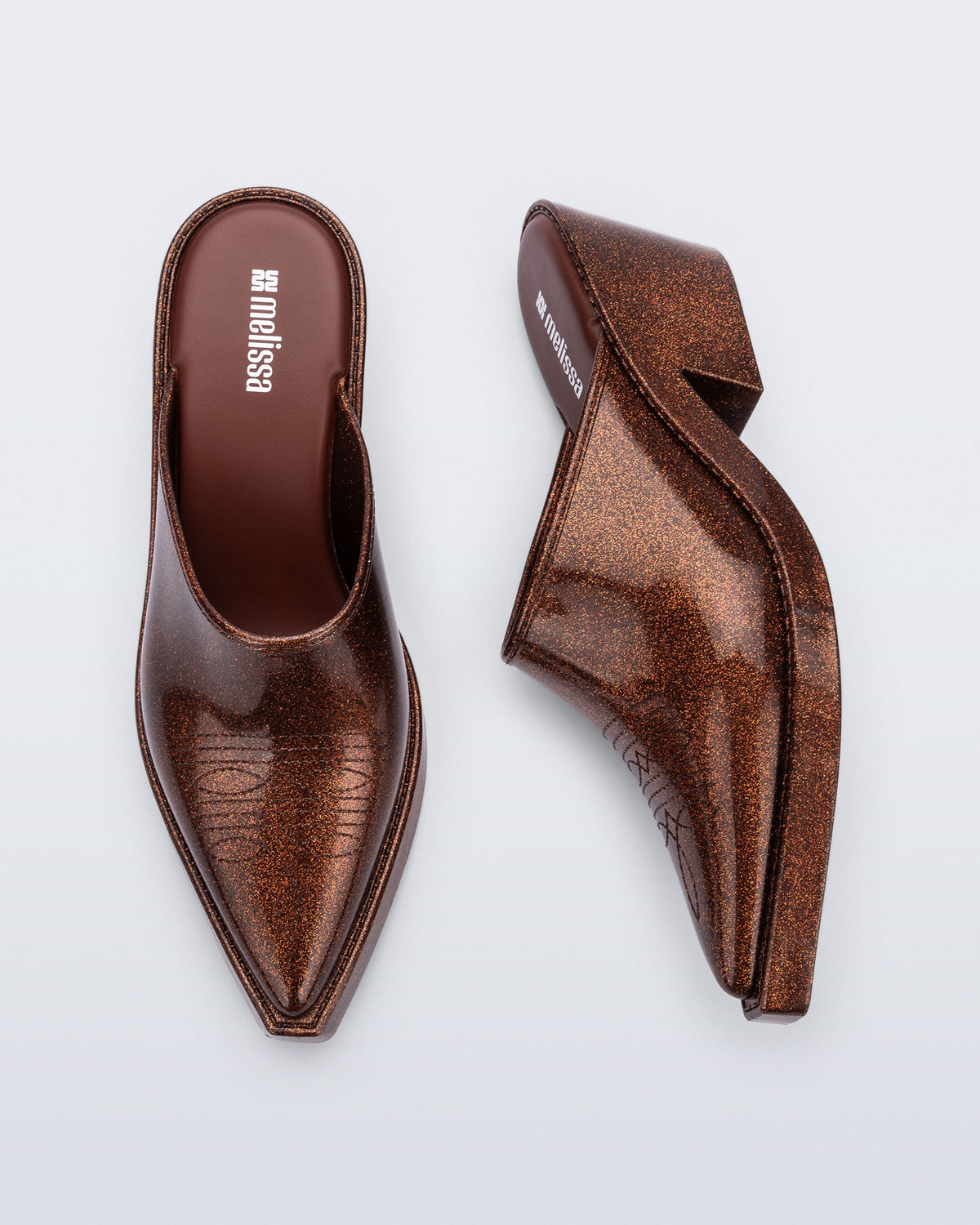 Side and top view of a pair of bronze glitter Texas Mule heels