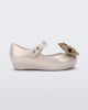 Side view of a beige Ultragirl Sweet baby ballerina flat with bow