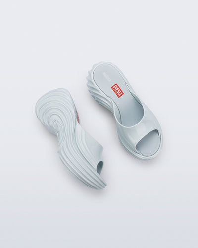 Top and side view of a pair of light blue Platforms + Diesel slides