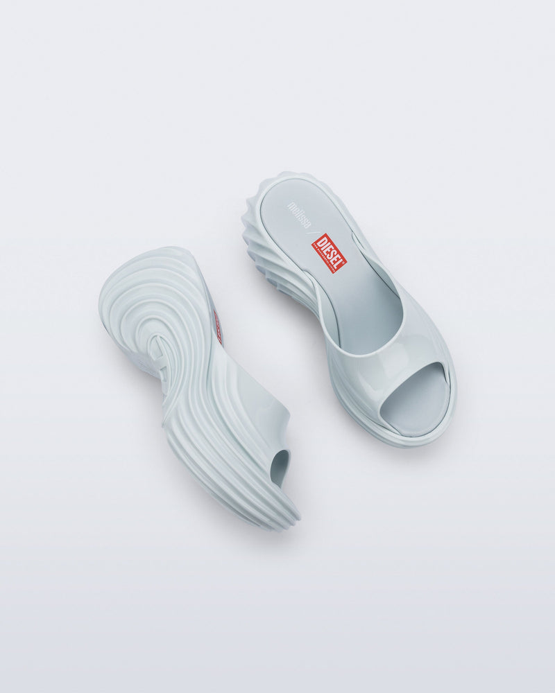Top and side view of a pair of light blue Platforms + Diesel slides