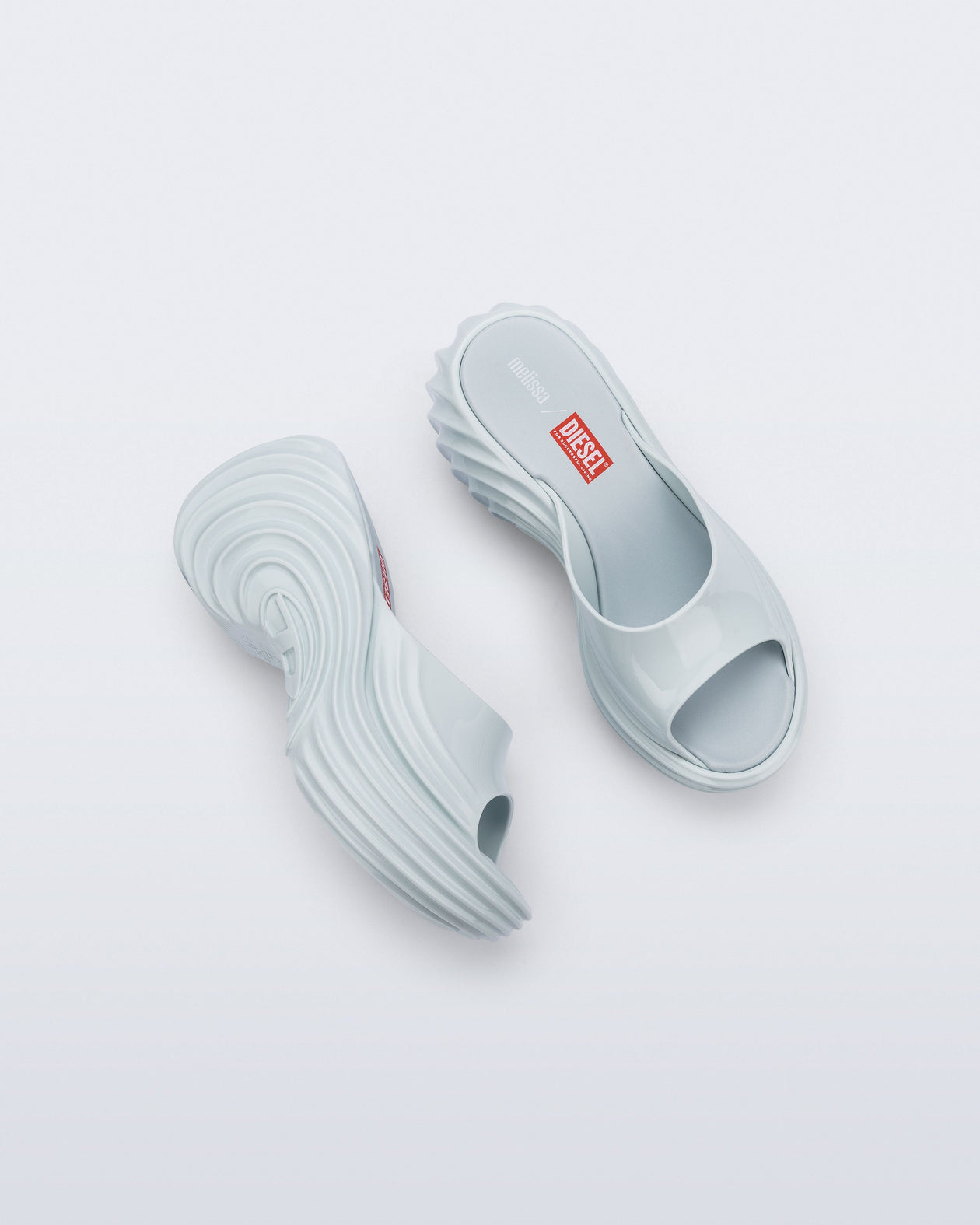 Top and side view of a pair of light blue Platforms + Diesel slides