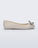 Side view of a beige Sweet Love Glam ballerina flat with chrome bow