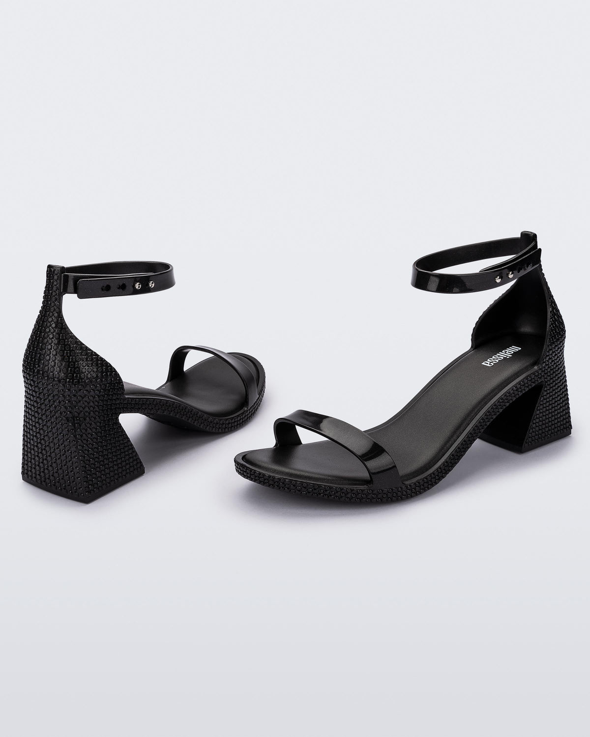 Angled view of a pair of metallic black Lux Heels