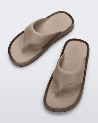 Top view of a pair of beige Float flip flops