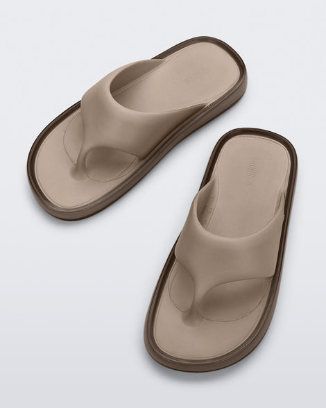 Top view of a pair of beige Float flip flops