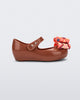 Side view of a brown with orange patterned bow Ultragirl Wonderland baby flat
