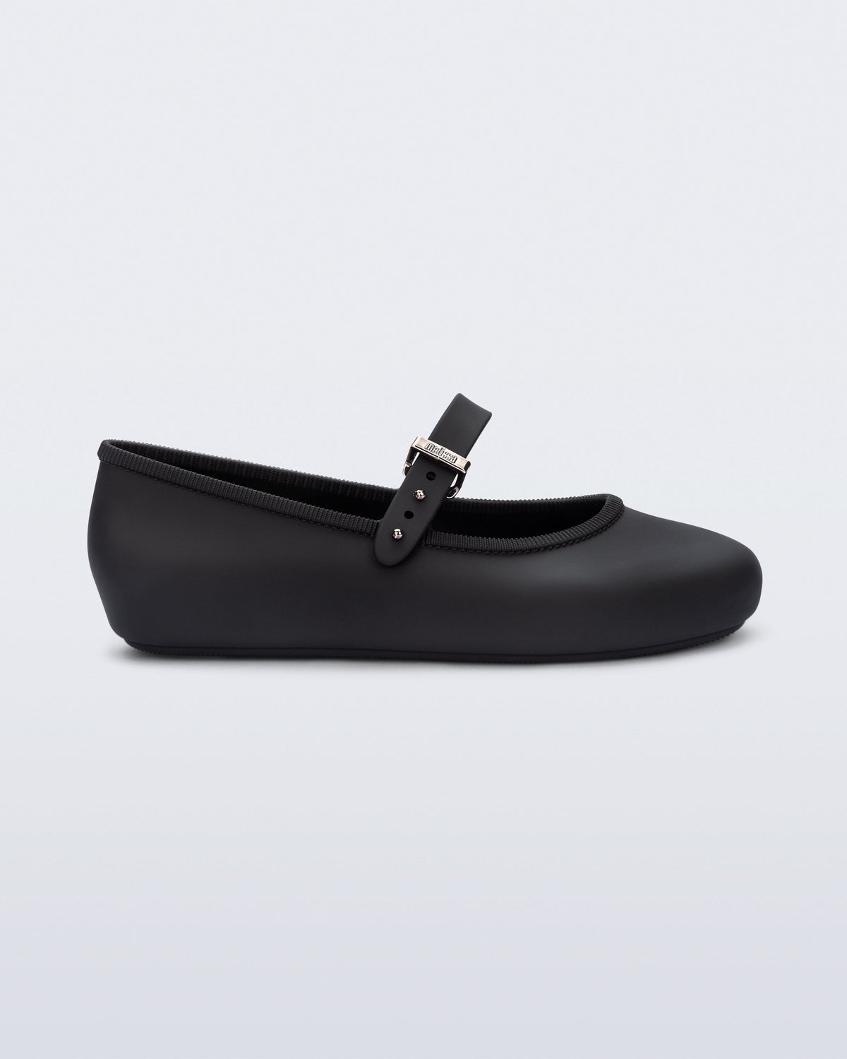 Side view of a black Soft Ballerina kids flat with strap