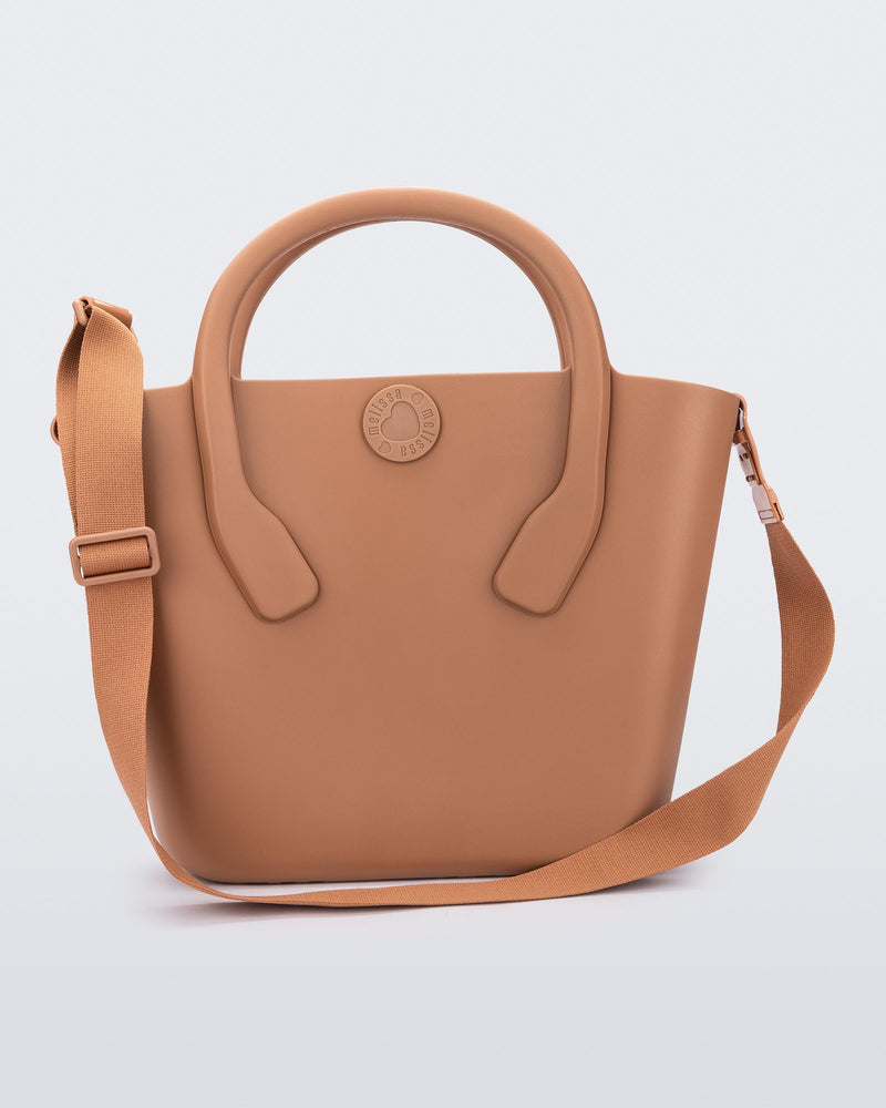 Front view of a brown Free Big Bag with handles and a strap