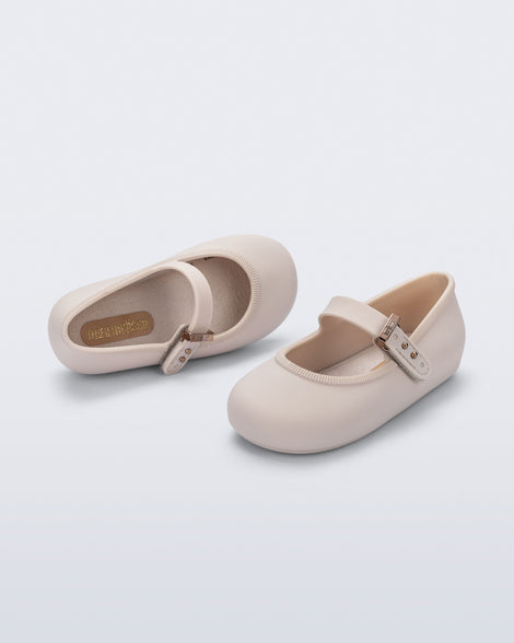 Top and side angled view of a pair of beige Soft Ballerina baby flat with Velcro strap