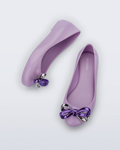 Top and side view of a pair of purple Sweet Love Glam kids ballerina flats with bow