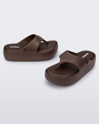 Side and angled view of a pair of bronze Free Platform Thong sandal