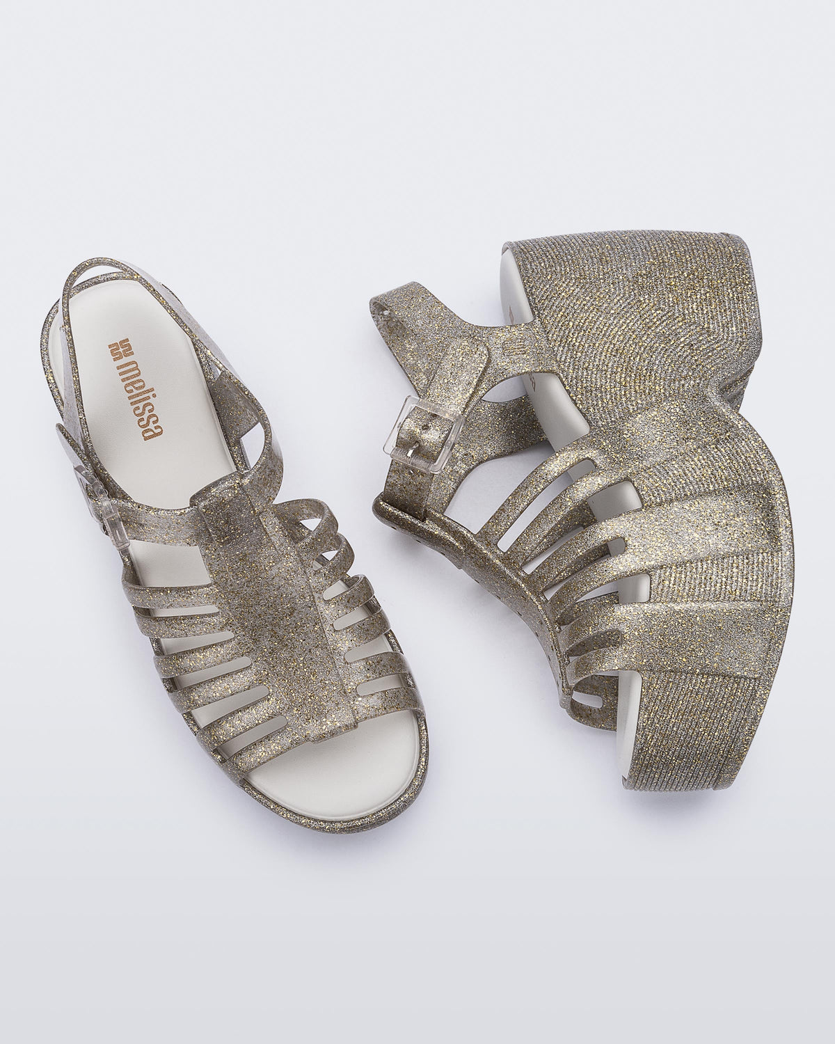 Top and side view of a pair of glitter gold Station 79 platform heels with ankle straps