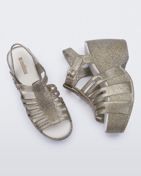 Top and side view of a pair of glitter gold Station 79 platform heels with ankle straps
