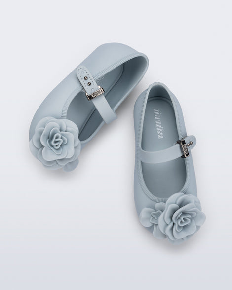 Top view of a pair of blue Soft Ballerina baby flats with blue flowers
