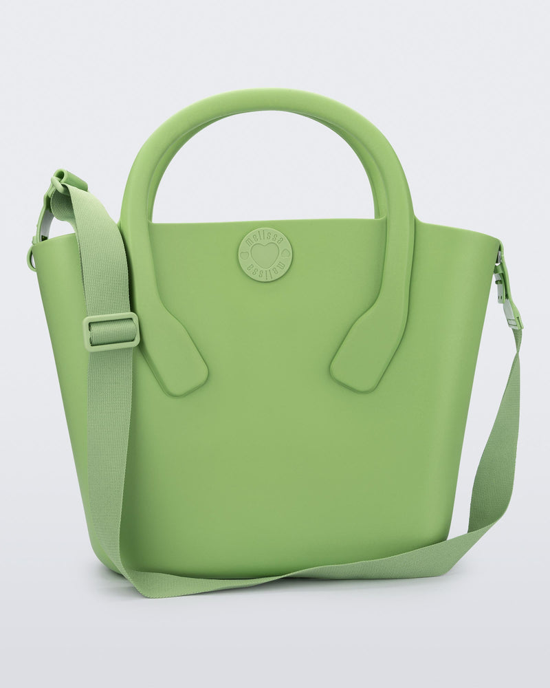 Front view of a green Free Big Bag with handles and a strap