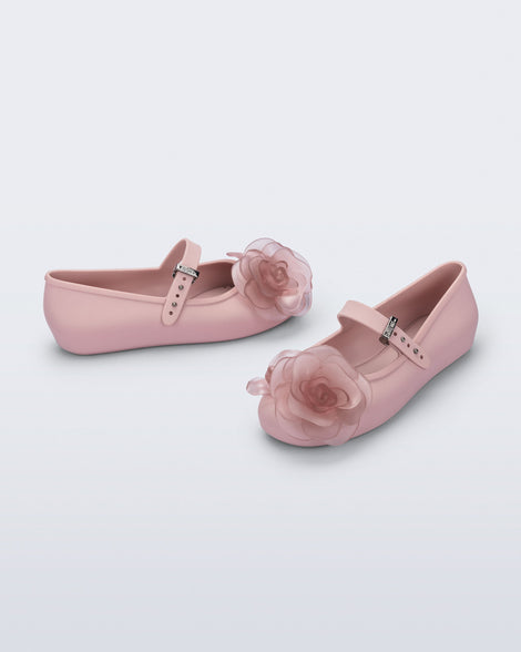 Side and angled view of a pair of beige Soft Ballerina Petals kids flats with clear pink flowers