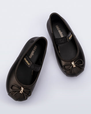 Top view of a pair of metallic black Sophie baby ballerina flats with bow