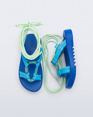 Side and top view of a pair of  blue sole, blue upper, and green ankle strap Kirk + Alexandre Pavao sandals