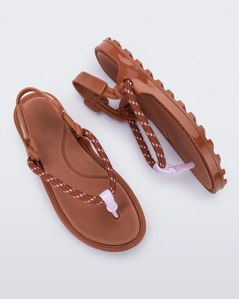 Top and side view of a pair of brown Bond sandals with textile strap and purple toe piece