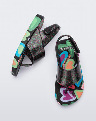 Top and side view of a pair of black glitter Shiny baby sandals with multicolor sole
