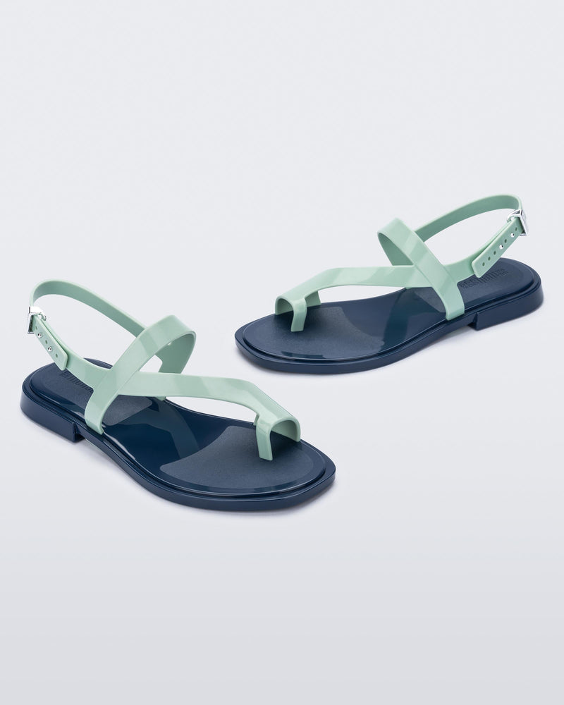 Angled view of pair of green Cassie sandals.