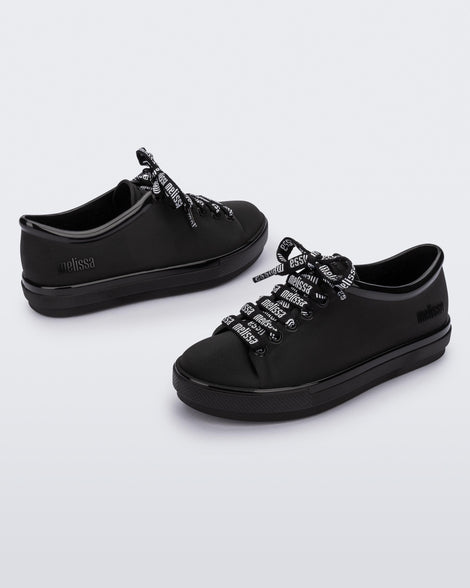 Angled view of a pair of black Hip M Lover kids sneakers with laces.