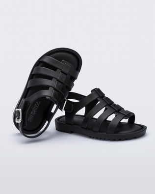 A top and side view of a pair of black Mini Melissa Flox sandals with straps.