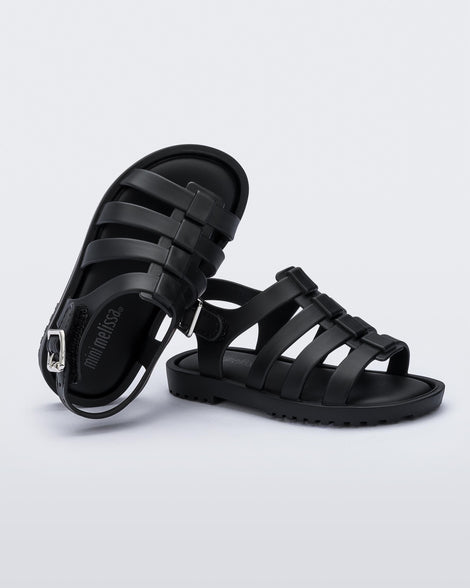 A top and side view of a pair of black Mini Melissa Flox sandals with straps.