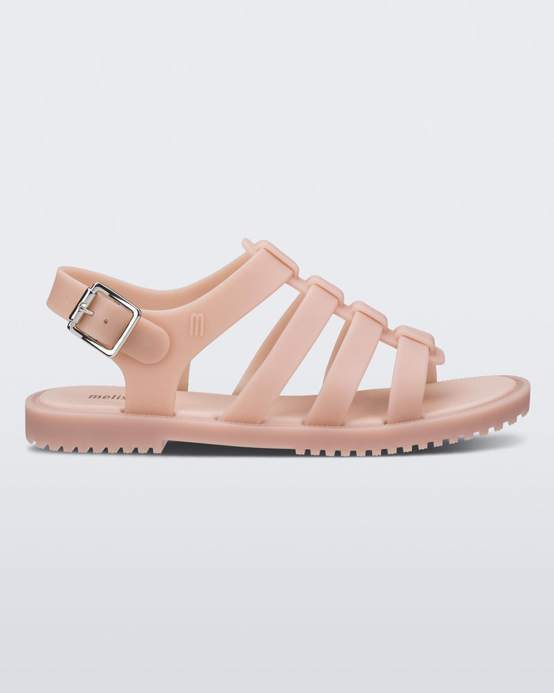 An outter side view of a beige Melissa Flox sandal with straps.