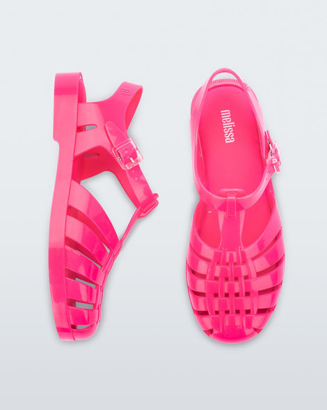 Side and top view of a pair of pink Possession fisherman style sandals.