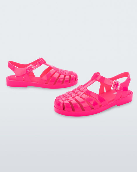 Side angled view of a pair of pink Possession fisherman style sandals.