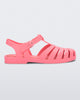 Side view of a coral pink Melissa Possesion sandal.
