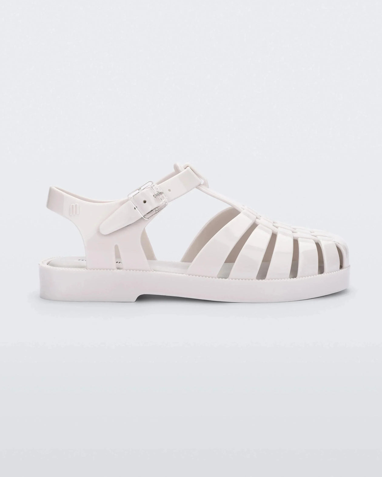 Side view of a white Mini Melissa Possession sandal with several straps and a white base.