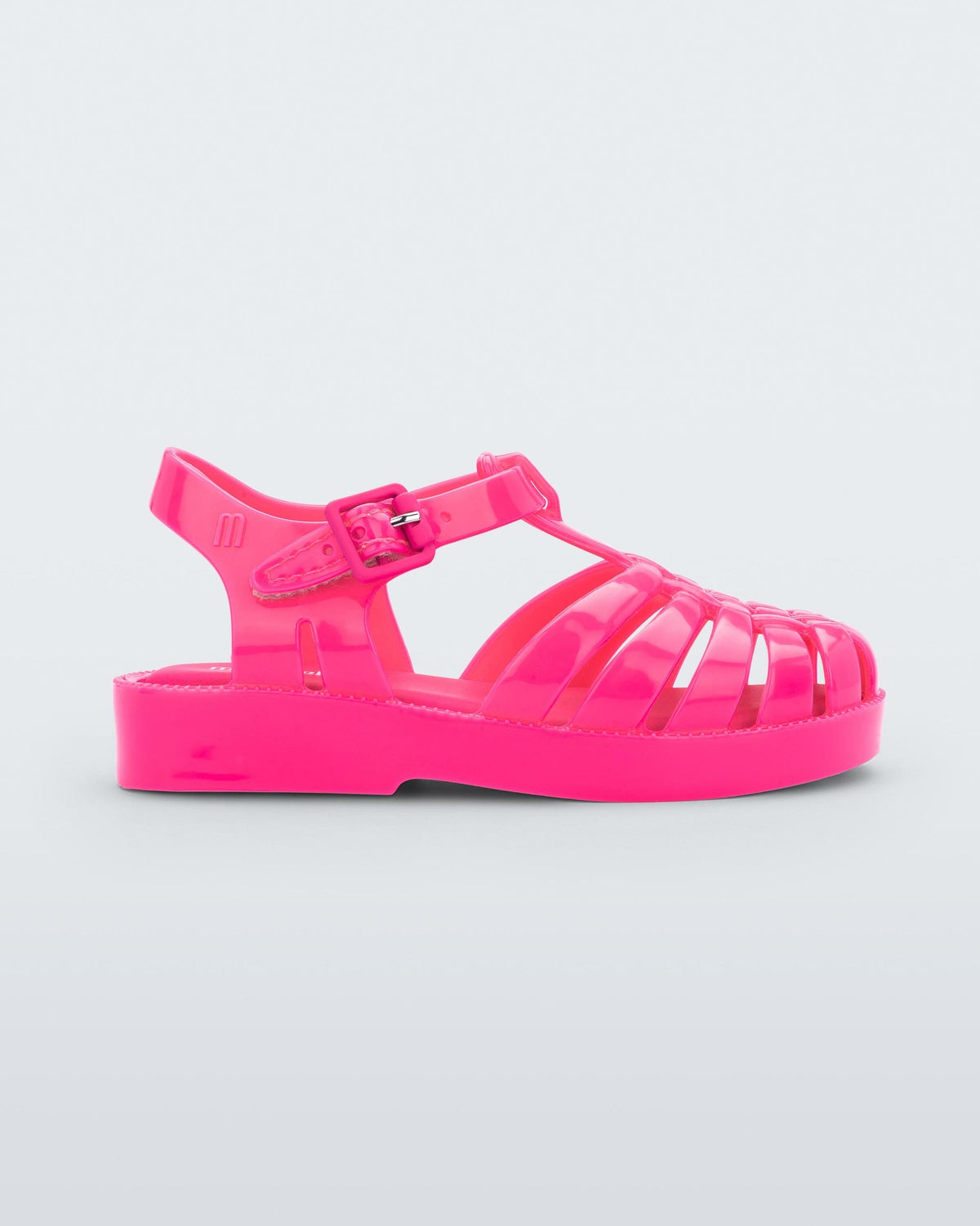 An outter side view of a pink Mini Melissa Possession sandal with several straps and a closed toe front.