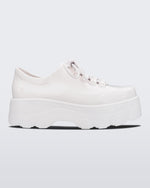 Side view of Melissa Kick Off platform sneaker in white. The sneaker has traditional white tie up laces.