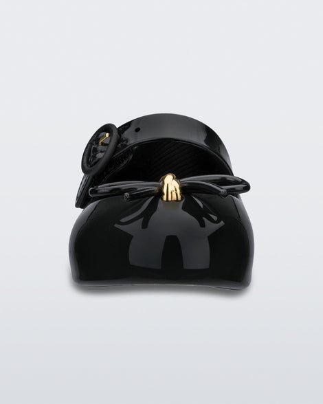 Front view of a black Mini Melissa Sweet Love flat with a top strap and a bow detail on the toe.