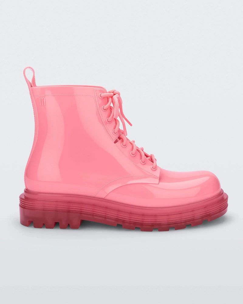 Side view of a pair of clear pink/pink Melissa Coturno boots with a pink base, laces and sole.