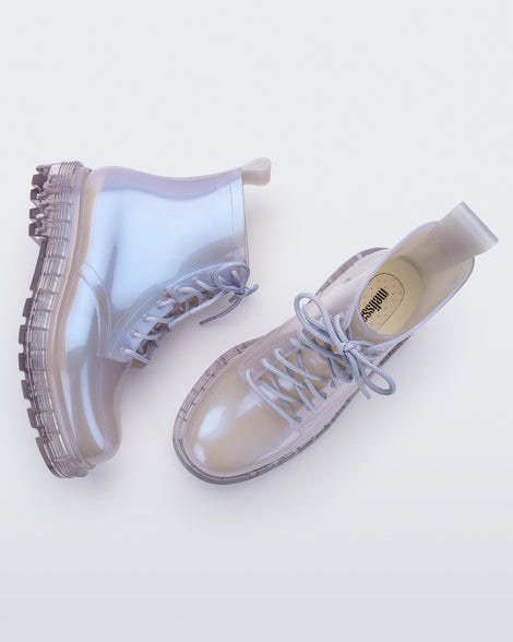 Side and top view of a pair of pearly lilac Melissa Coturno boots.