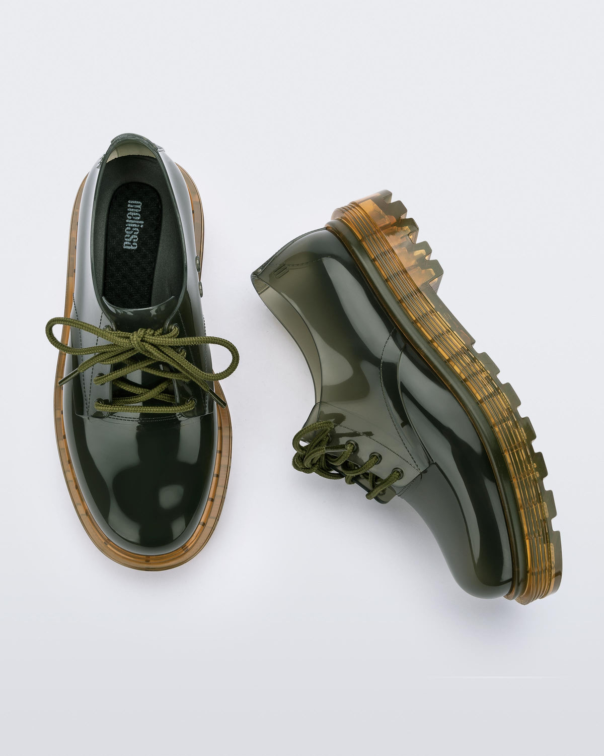 A top and side view of a pair of clear green / yellow Melissa Bass sneakers, with a transparent green base, green laces and a transparent yellow sole.