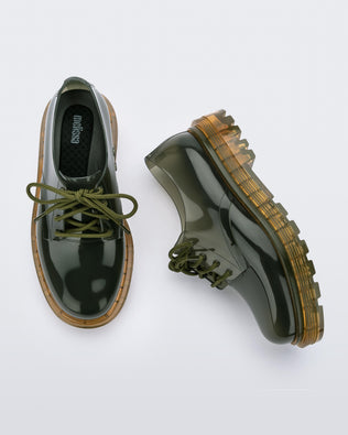 A top and side view of a pair of clear green / yellow Melissa Bass sneakers, with a transparent green base, green laces and a transparent yellow sole.