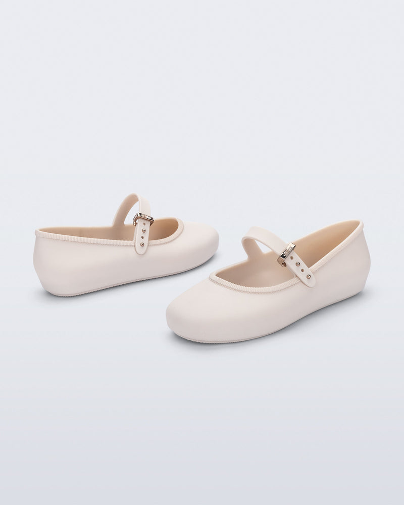 Back and side angled view of a pair of beige Soft Ballerina kids flat with strap