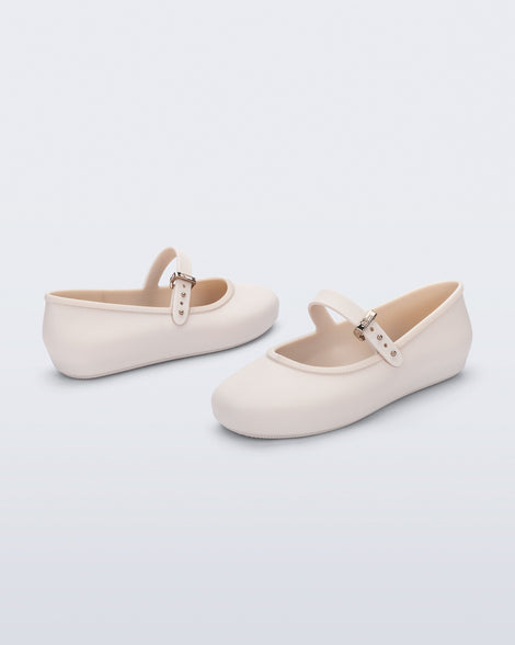 Back and side angled view of a pair of beige Soft Ballerina kids flat with strap