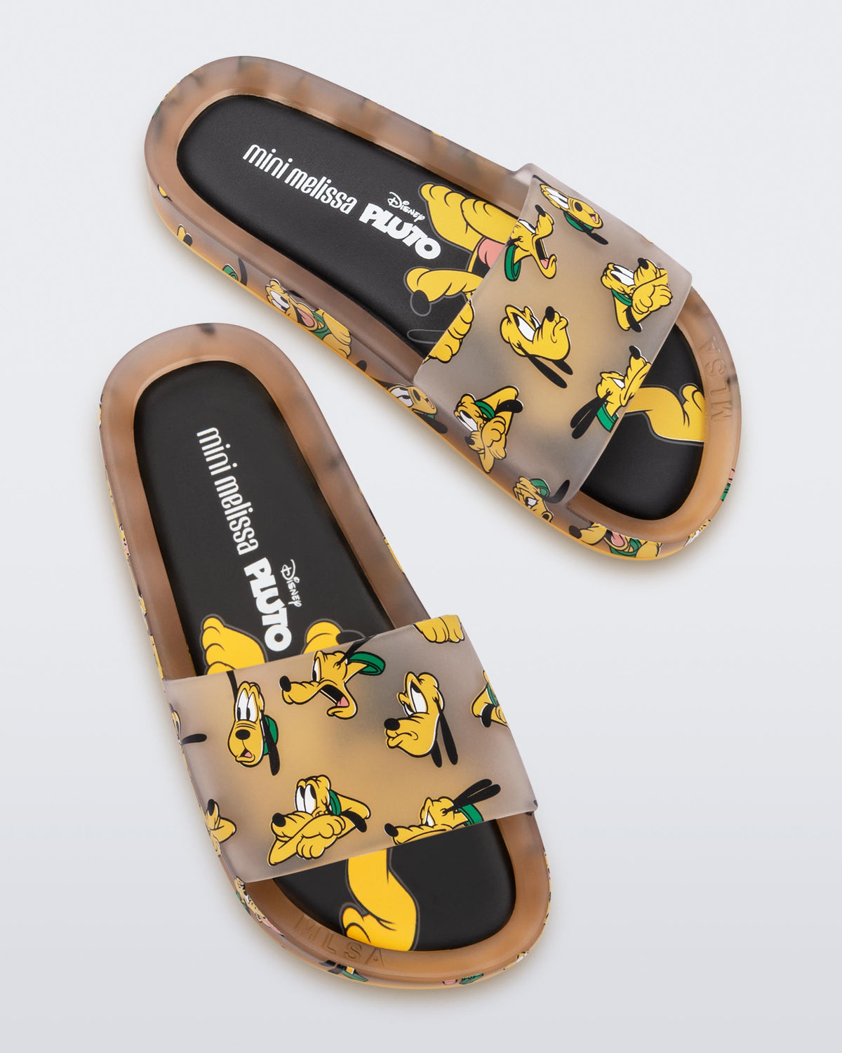 Top view of a clear beige / yellow Mini Melissa Beach slides with a beige base and a pattern of Disney's Pluto the dog with different facial expressions.