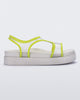 Side view of a beige/green Melissa Bikini platform sandal with two transparent green straps conjoining in the middle and a beige sole.