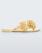 Side view of a yellow Melissa Harmonic Garden flip flop with flowers on the straps.