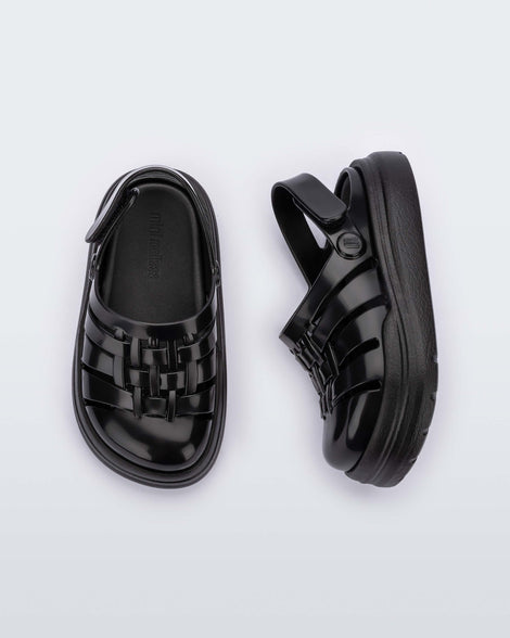 A top and side view of a pair of black Mini Melissa Sunday sandals with woven closed toe front and back ankle strap.