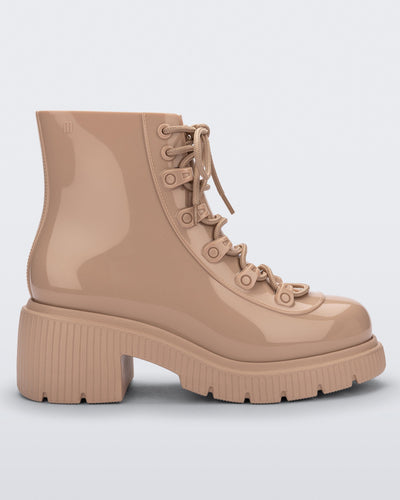 Side view of a beige Melissa Cosmo boot.